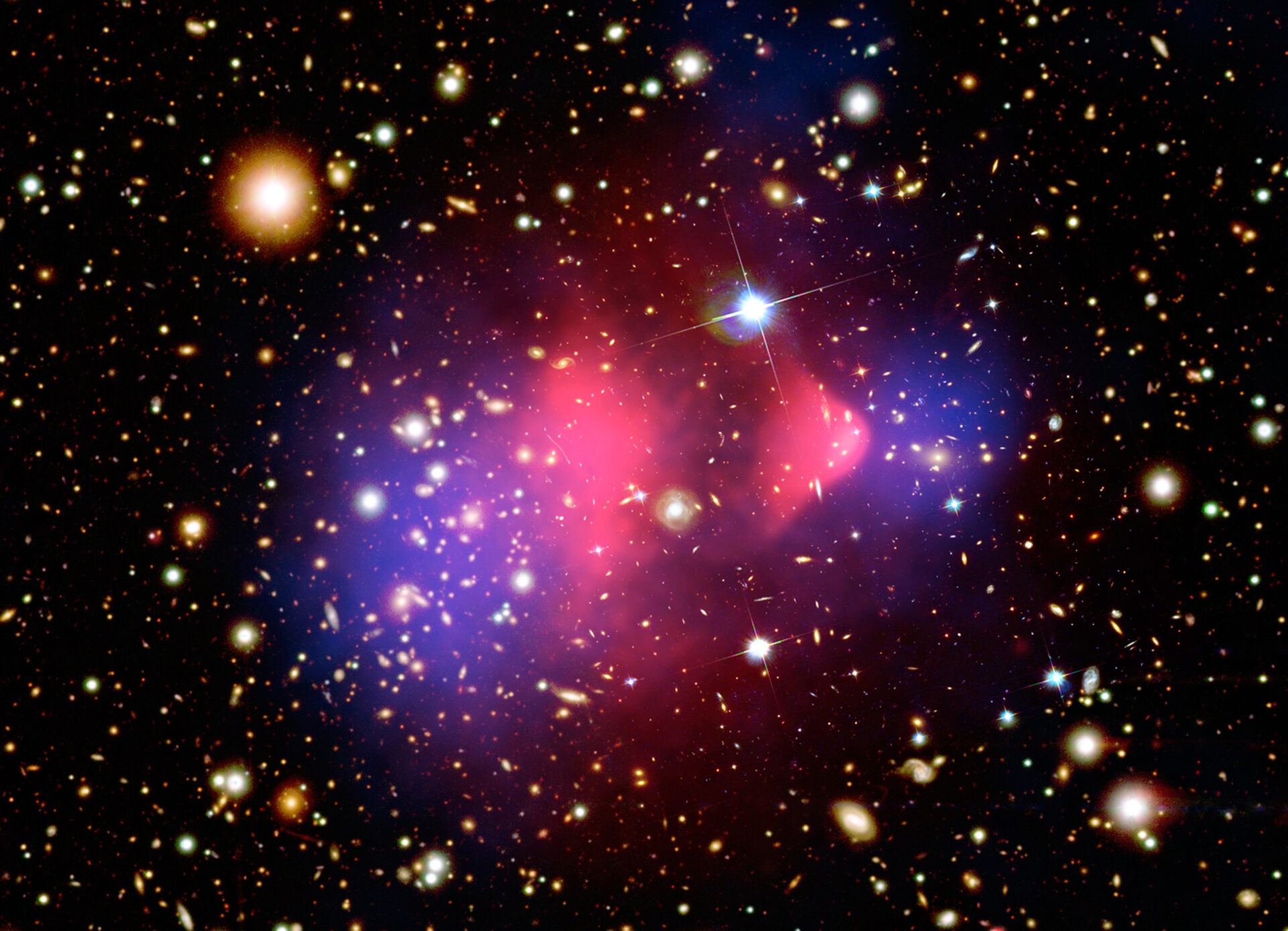 big crunch universe — composite image of the Bullet Cluster showing two galaxy clusters colliding, with dark matter in blue and hot gas in pink, demonstrating gravity dominating at cosmic scales