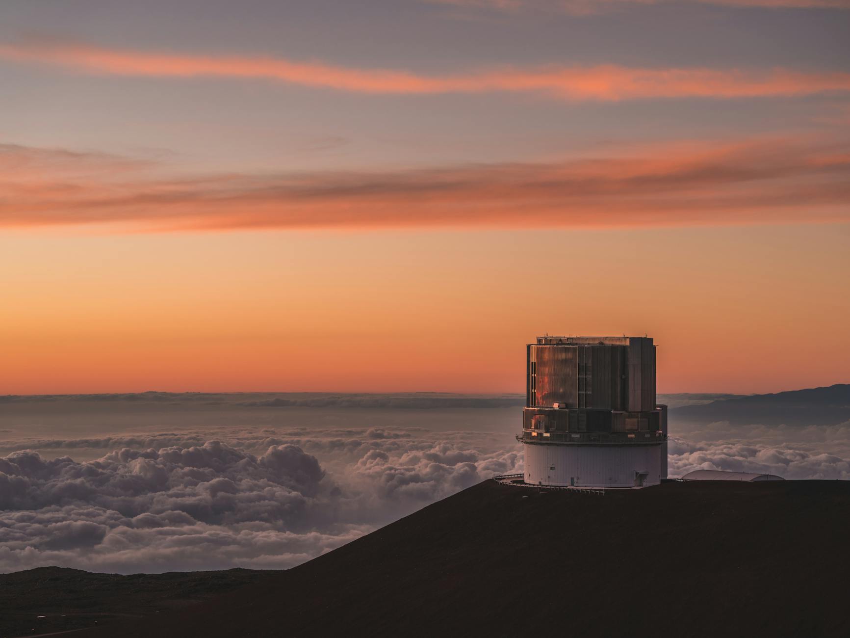 Telescope domes at Mauna Kea Observatory at sunset