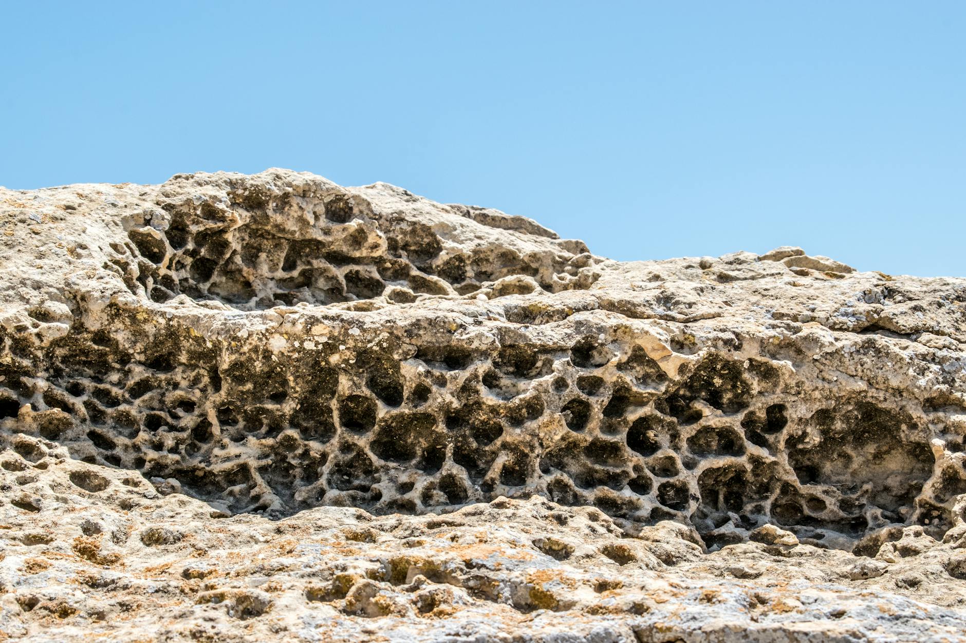 Eroded limestone rock weathering under an open sky