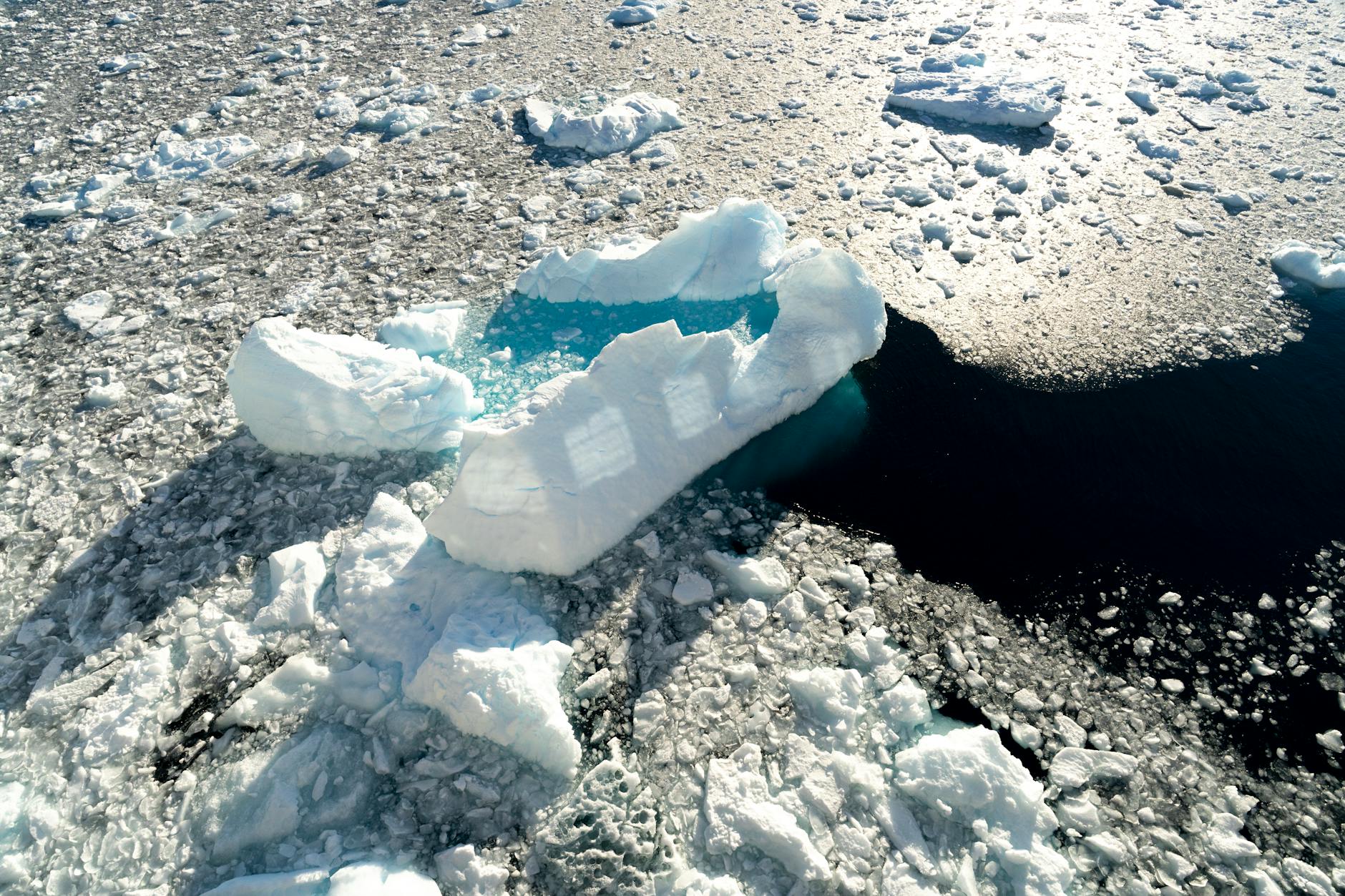Ice melting in water, a classic example of entropy increasing as an ordered solid becomes a disordered liquid.