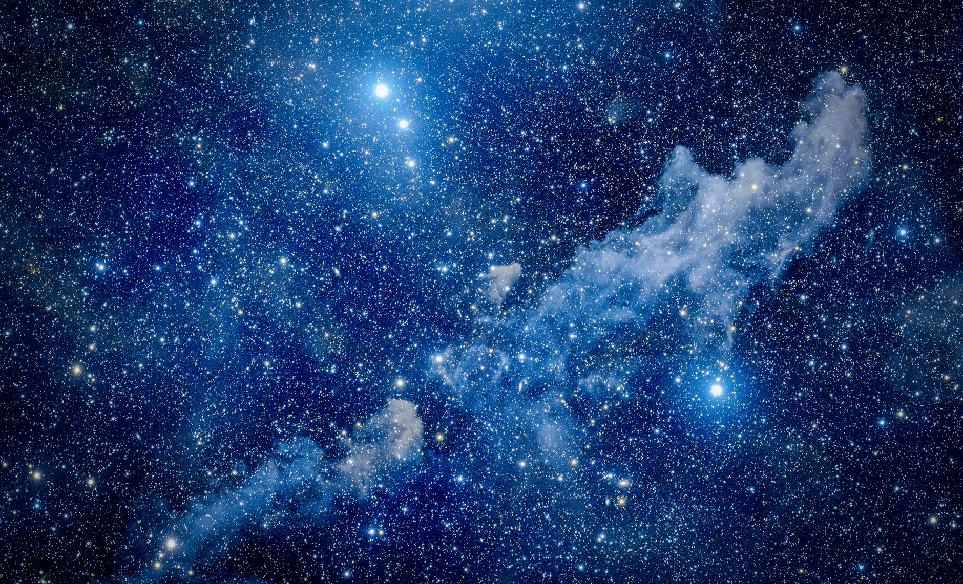 A glowing nebula and star field among which white dwarfs slowly fade, illustrating how white dwarfs cool over time.