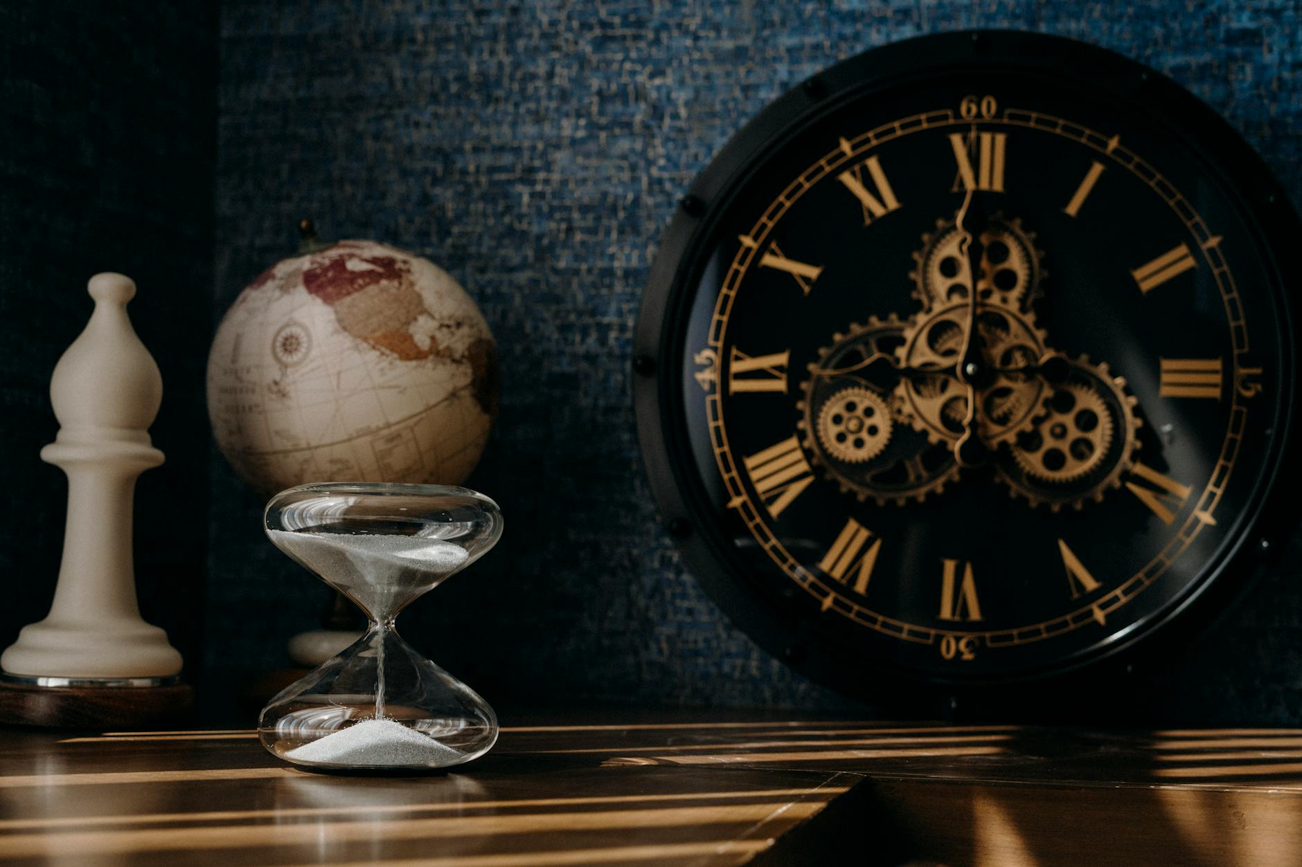 what is time physics — An hourglass measuring time against a cosmic background, representing the mystery of time in physics.
