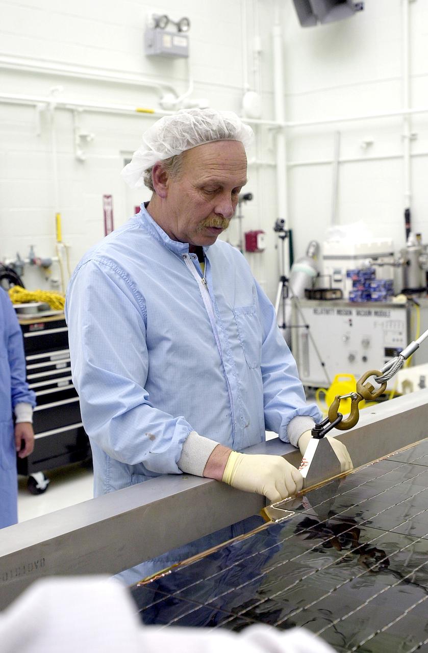 Technicians preparing NASA's Gravity Probe B spacecraft