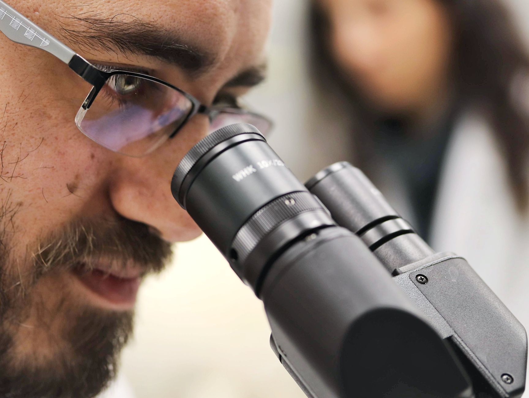Scientists in a neuroscience laboratory conducting research on memory engrams using advanced imaging and optogenetics techniques.