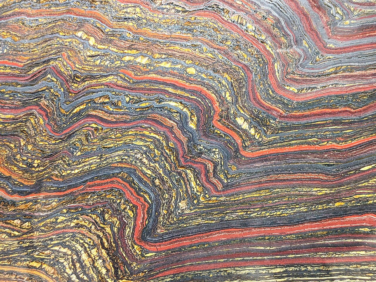 A banded iron formation with alternating red and dark layers
