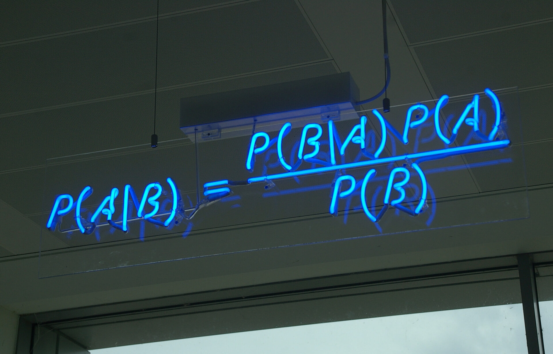 Bayes' theorem written out in blue neon tubing