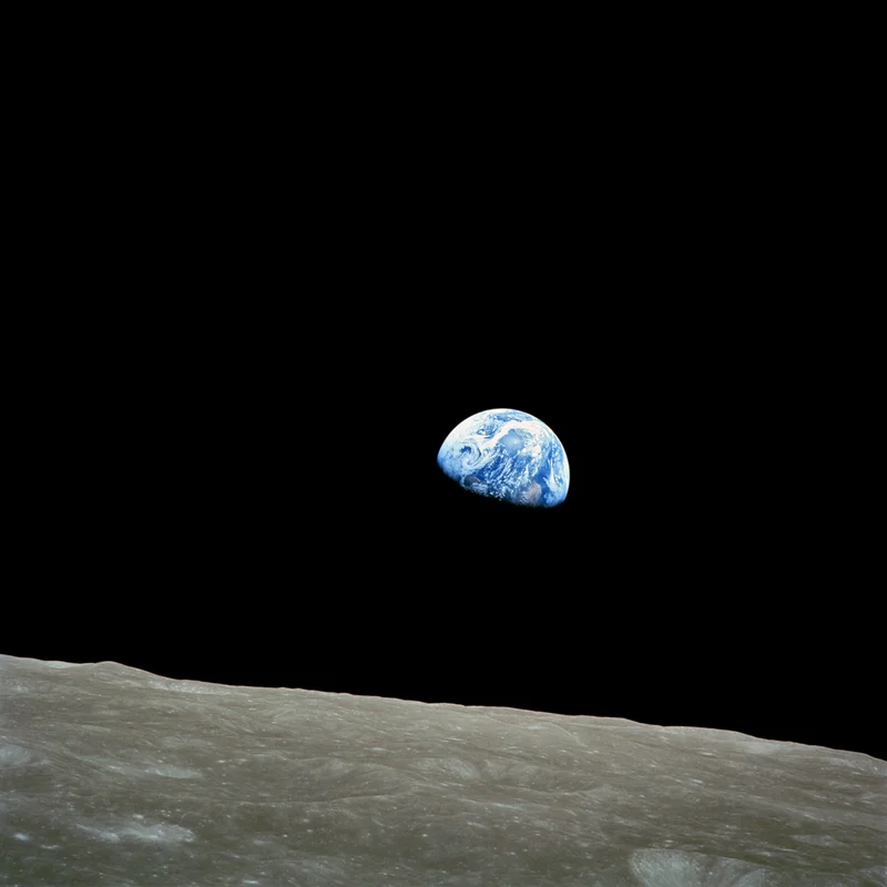 Earthrise: Earth rising over the lunar horizon, photographed by the Apollo 8 crew.