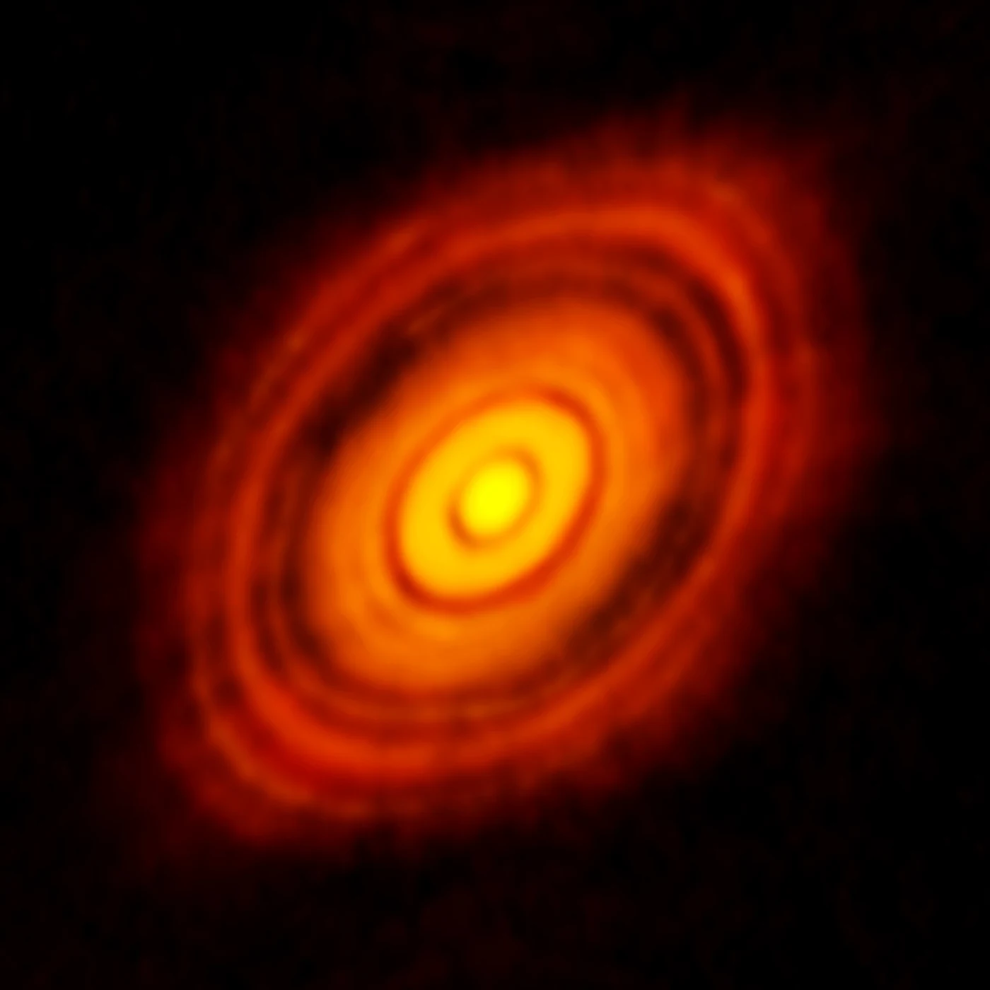 ALMA radio image of the protoplanetary disk around the young star HL Tauri, showing concentric rings and gaps carved by forming planets